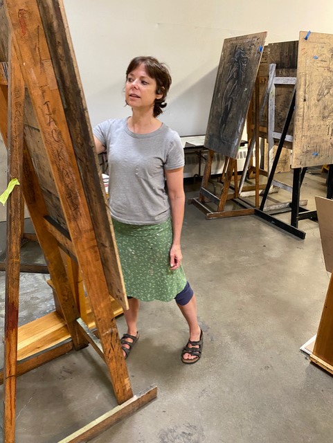 artist drawing at an easel