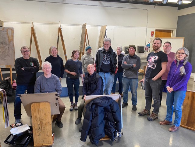 Group photo of artists in a drawing room.